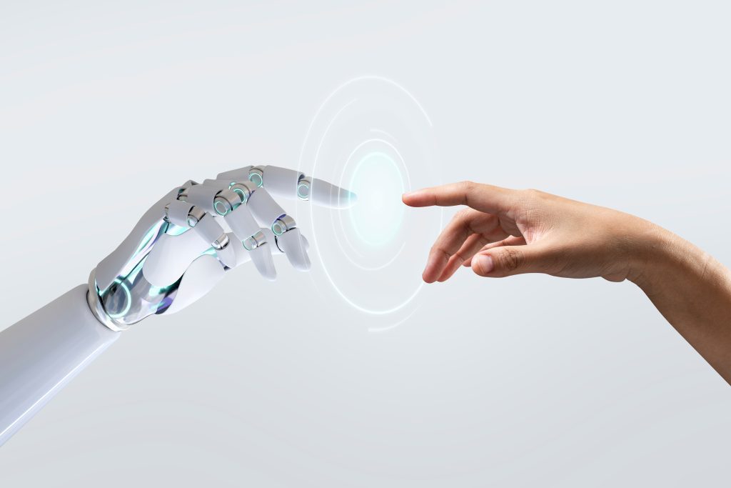 Inteligência artificial em comunidades representada por uma mão robótica tocando uma mão humana.